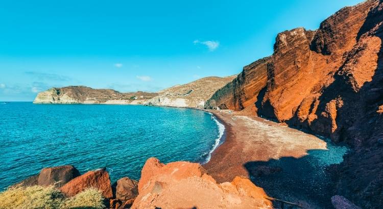 Solo Travel in Santorini – Lounge on Santorini’s unique beaches, such as the Famous Red Beach